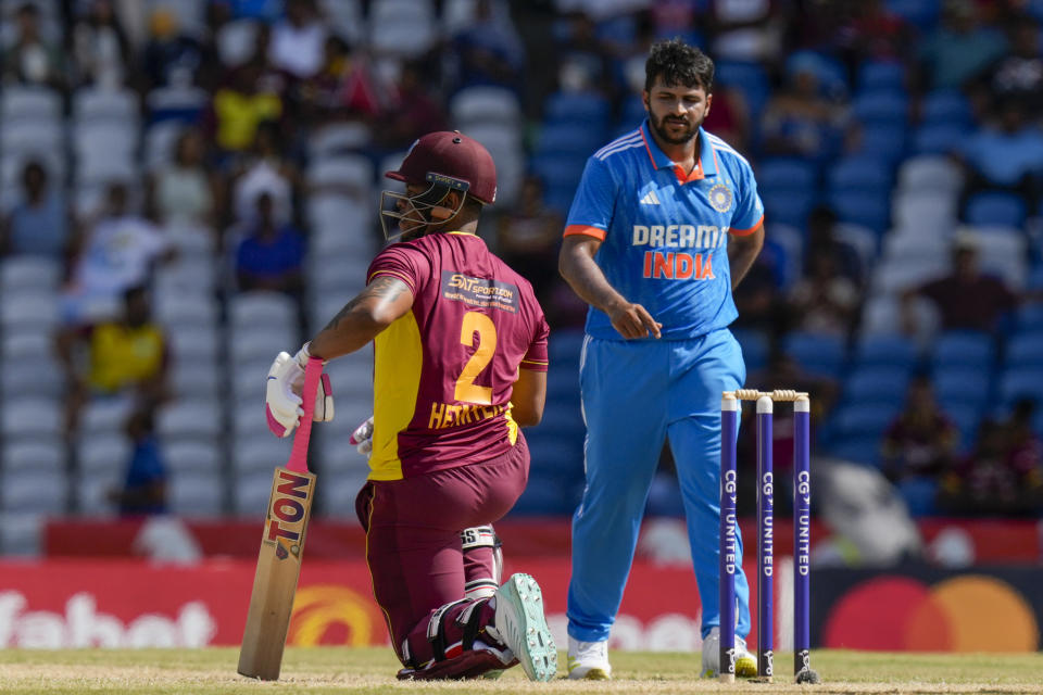 West Indies' Shimron Hetmyer kneels after being dismissed by India's Shardul Thakur, right, during the third ODI cricket match at the Brian Lara Stadium in Tarouba, Trinidad and Tobago, Tuesday, Aug. 1, 2023. (AP Photo/Ramon Espinosa)