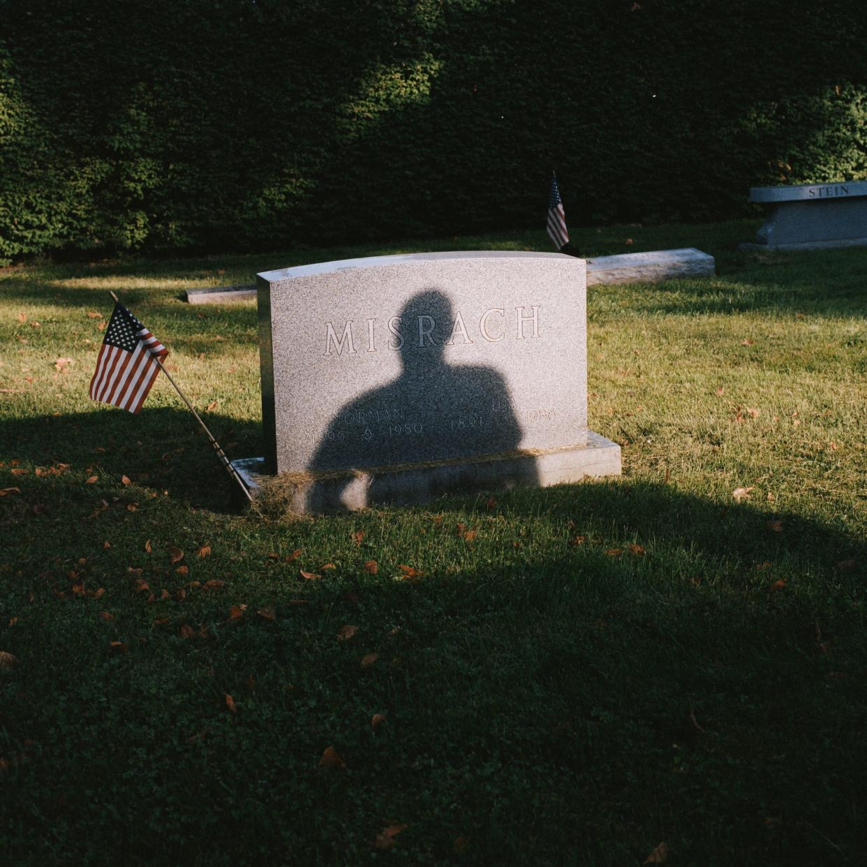 Foreman Ronnie King casts a shadow on a gravestone at the Walnut Hills Cemetery in September.