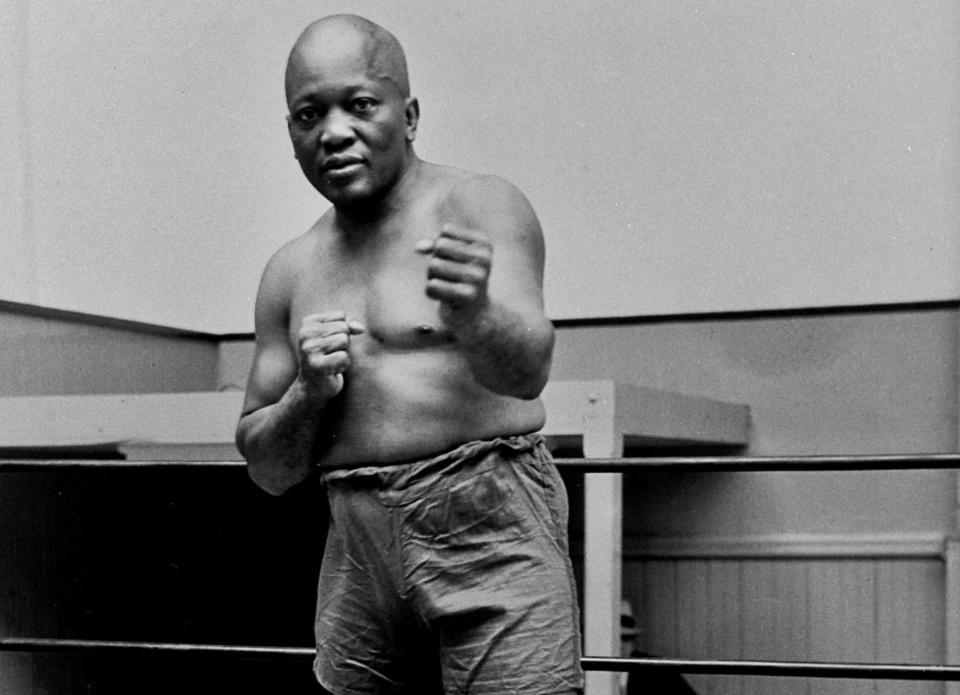 FILE - In this 1932 file photo, boxer Jack Johnson, the first black world heavyweight champion, poses in New York City. President Donald Trump on Thursday, May 24, 2018, granted a rare posthumous pardon to boxing's first black heavyweight champion, clearing Jack Johnson's name more than 100 years after a racially-charged conviction. Sylvester Stallone has announced plans for a biopic on the first African American heavyweight champion. (AP Photo/File)