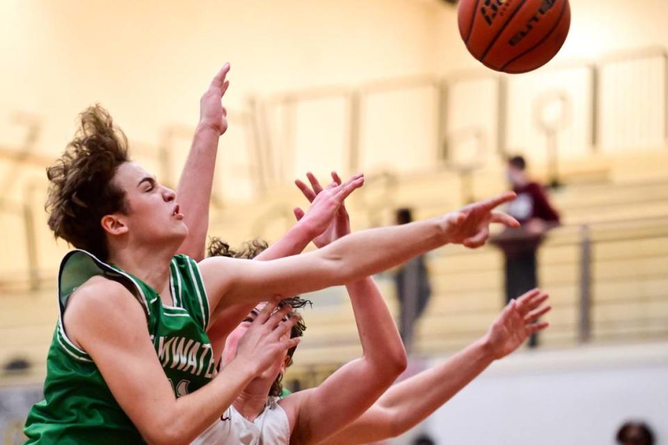 Tumwater guard Connor Hopkins (21) knocks a defensive rebound out of the hands of Capital forward Rylan Hill (44) during the second quarter of a non-league game in Olympia on Saturday, Jan. 22, 2022.