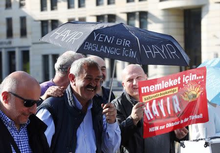 People attend an anti-Turkish President Tayyip Erdogan prostest in front of the Brandenburg Gate in Berlin, Germany, April 1, 2017. REUTERS/Fabrizio Bensch