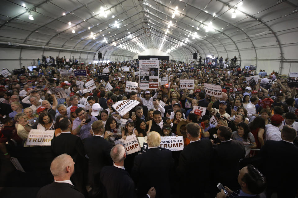 FILE - Republican presidential candidate Donald Trump, center, signs autographs after speaking at a rally, Thursday, June 2, 2016, in San Jose, Calif. (AP Photo/Jae C. Hong, File)