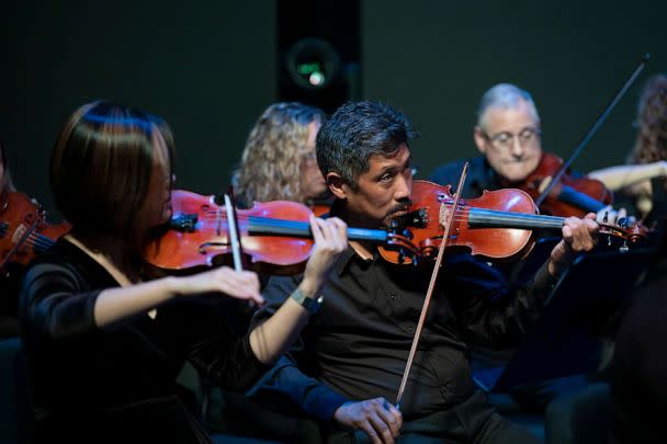 PHOTO: Dr. Vincent Hsu plays the violin during AdventHealth's all-employee orchestra's first performance: a requiem for those who died during the pandemic, summer 2021. (Matt Rainey/AdventHealth)