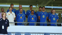 The Australian cricket team stands for a minute's silence at the WACA.