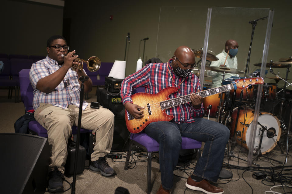 Musicians play their instruments during a church service at the New Horizon International Church, Sunday, Oct. 4, 2020, in Jackson, Miss. The virus ripped through Mississippi's Black community early in the pandemic. About 60% of infections and deaths were among African Americans, who make up 38% of the state's population. (AP Photo/Wong Maye-E)