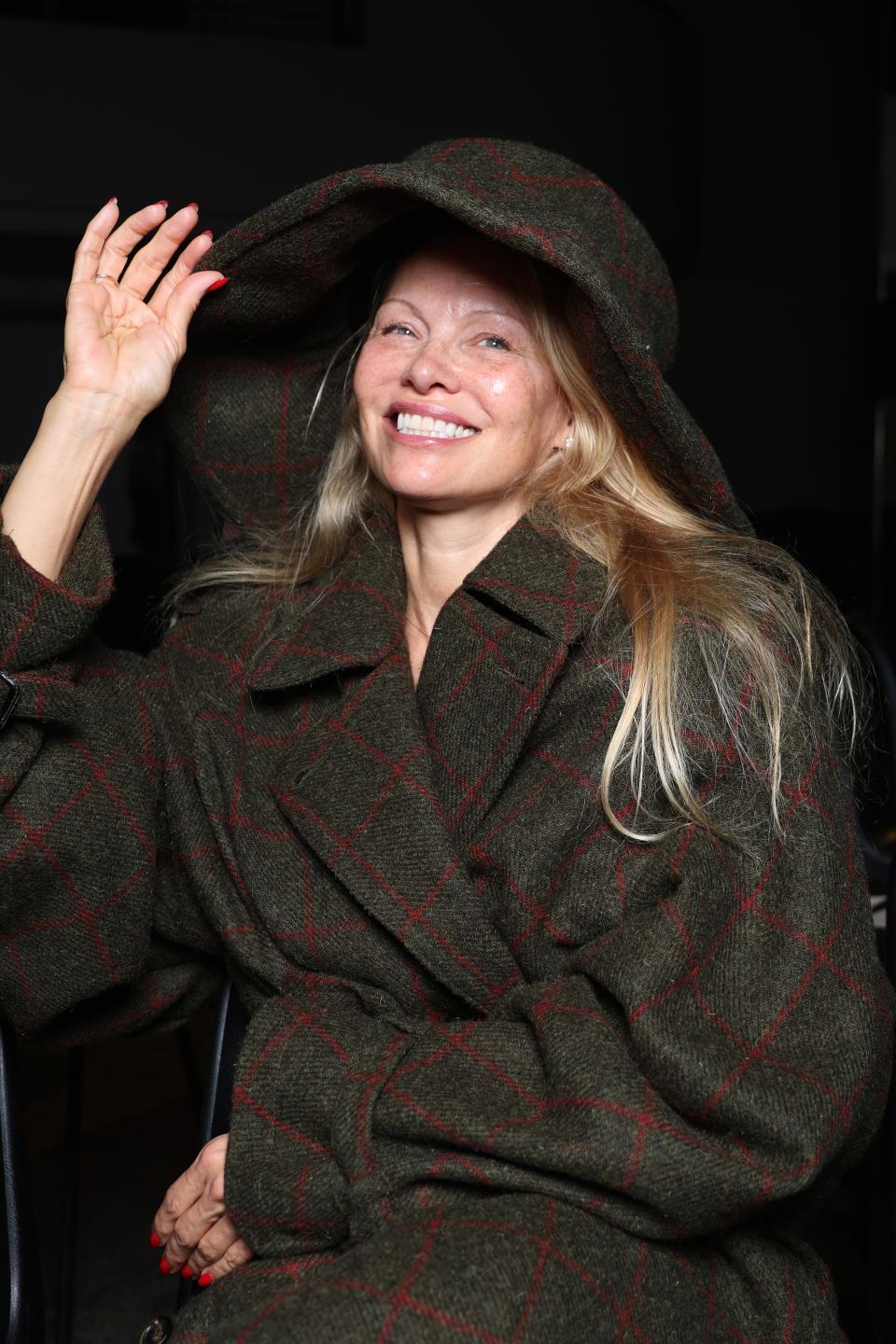 Pamela Anderson goes makeup free during the Vivienne Westwood show duirng Paris Fashion Week in fall of last year.