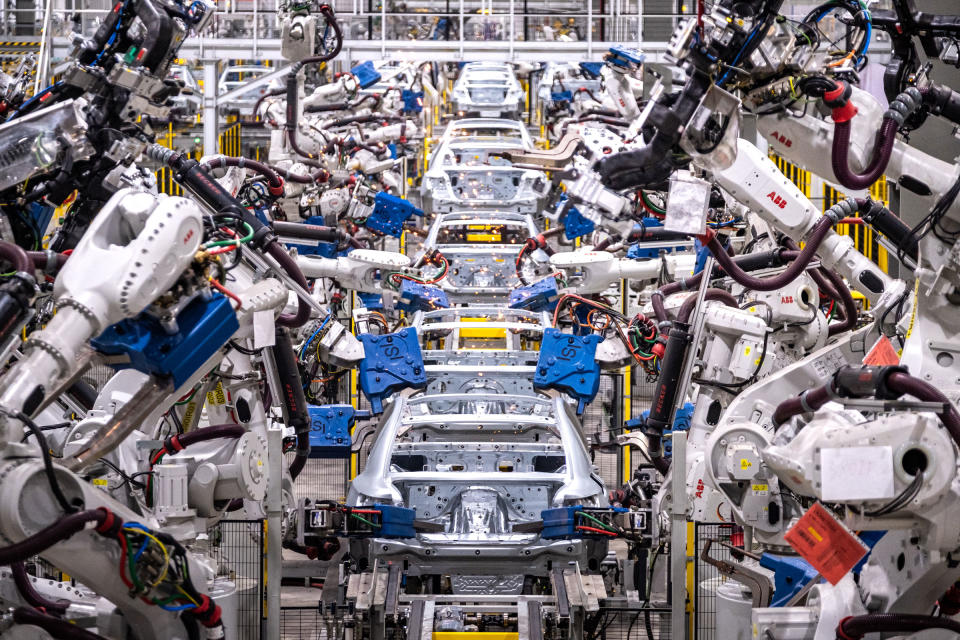 Assembly robots put together car bodies in the body shop at VinFast manufacturing plant in Haiphong.<span class="copyright">Linh Pham for TIME</span>