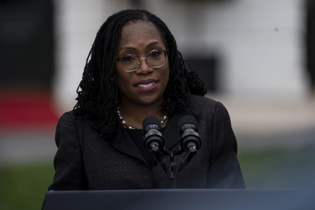 Ketanji Brown Jackson speaks into microphones from a podium at the White House.