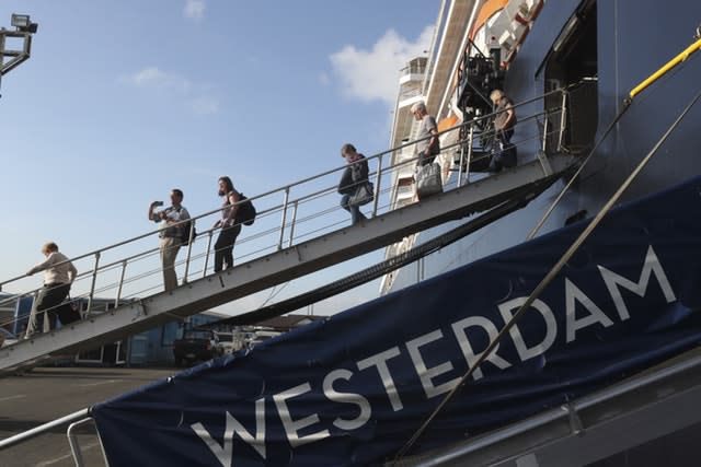 Passengers disembark from the MS Westerdam