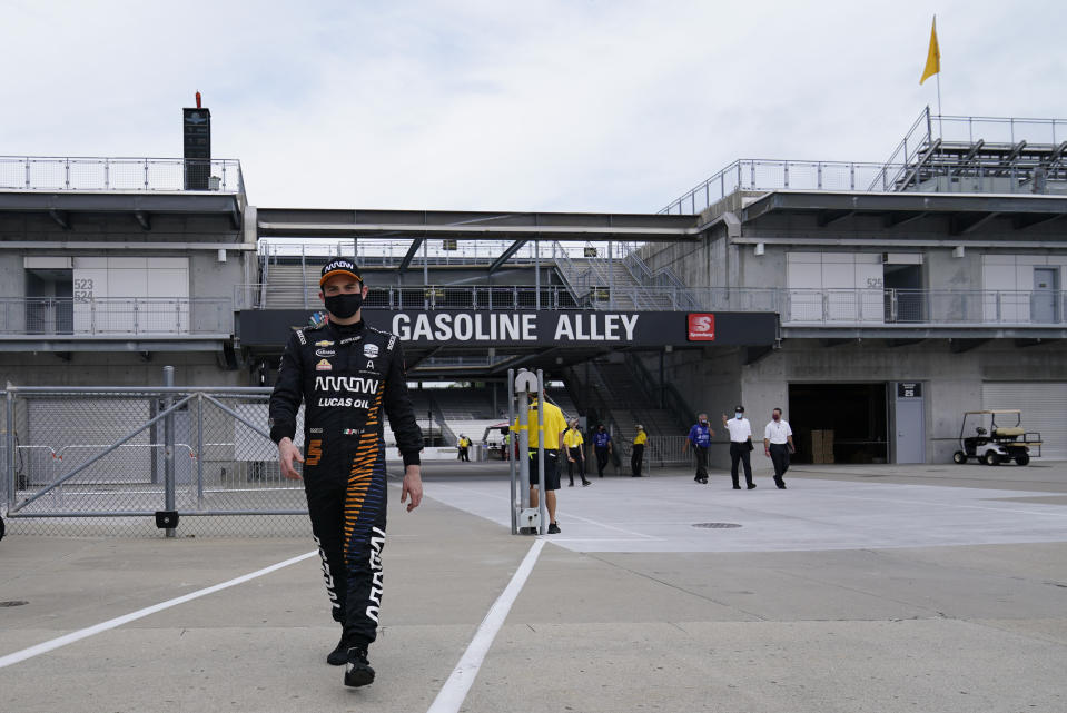 Pato O'Ward, of Mexico, walks back to the garage area during a practice session for the Indianapolis 500 auto race at Indianapolis Motor Speedway, Wednesday, Aug. 12, 2020, in Indianapolis. (AP Photo/Darron Cummings)