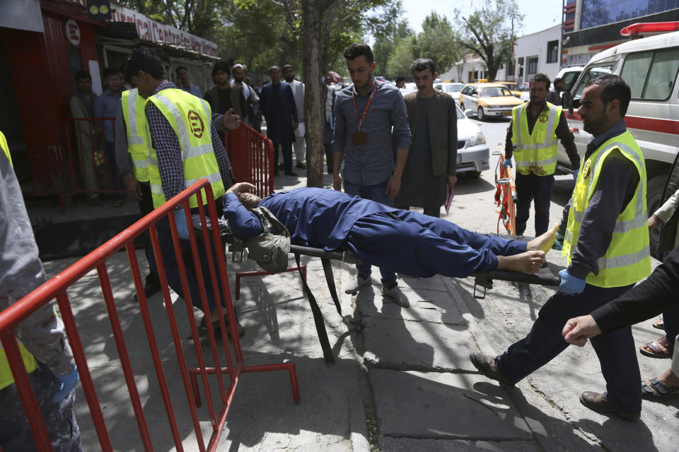 <p>Afghan men carries a wounded man after the second blast in Kabul, Afghanistan, April 30, 2018. (Photo: Rahmat Gul/AP) </p>