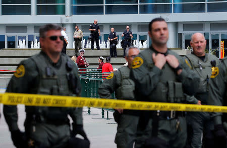 Members of the Anaheim Police Department (rear) and the Orange County Sheriff stand watch outdoors before Republican U.S. Presidential candidate Donald Trump speaks at a campaign event in Anaheim, California U.S. May 25, 2016. REUTERS/Mike Blake