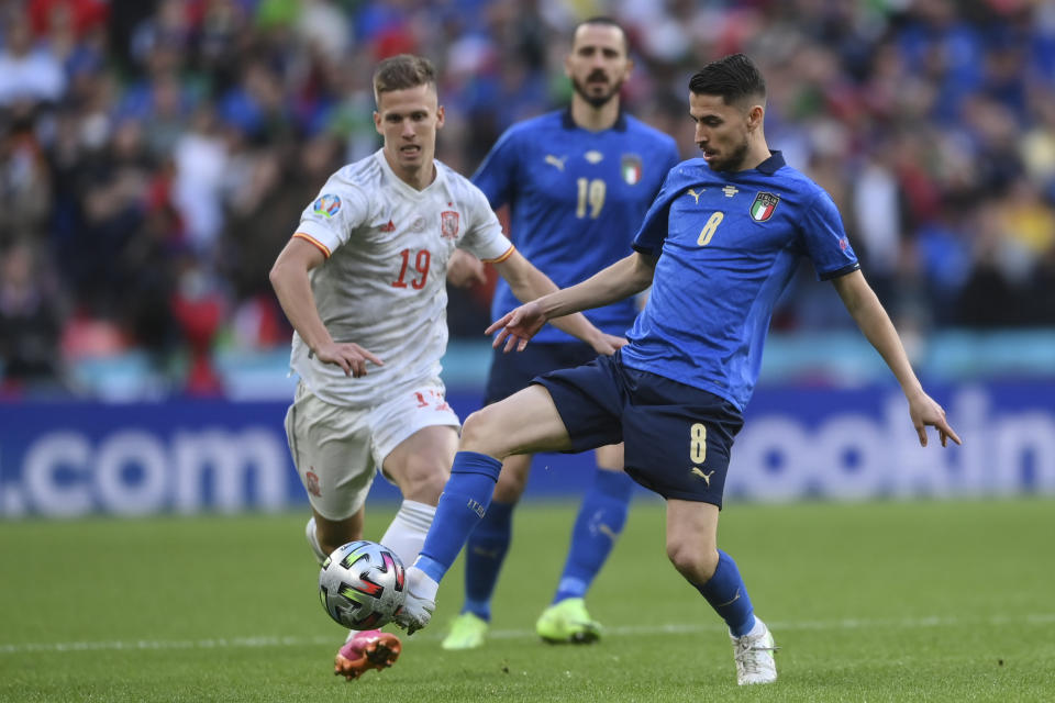 Italy's Jorginho gets the ball past Spain's Dani Olmo during the Euro 2020 soccer semifinal match between Italy and Spain at Wembley stadium in London, Tuesday, July 6, 2021. (Laurence Griffiths, Pool via AP)