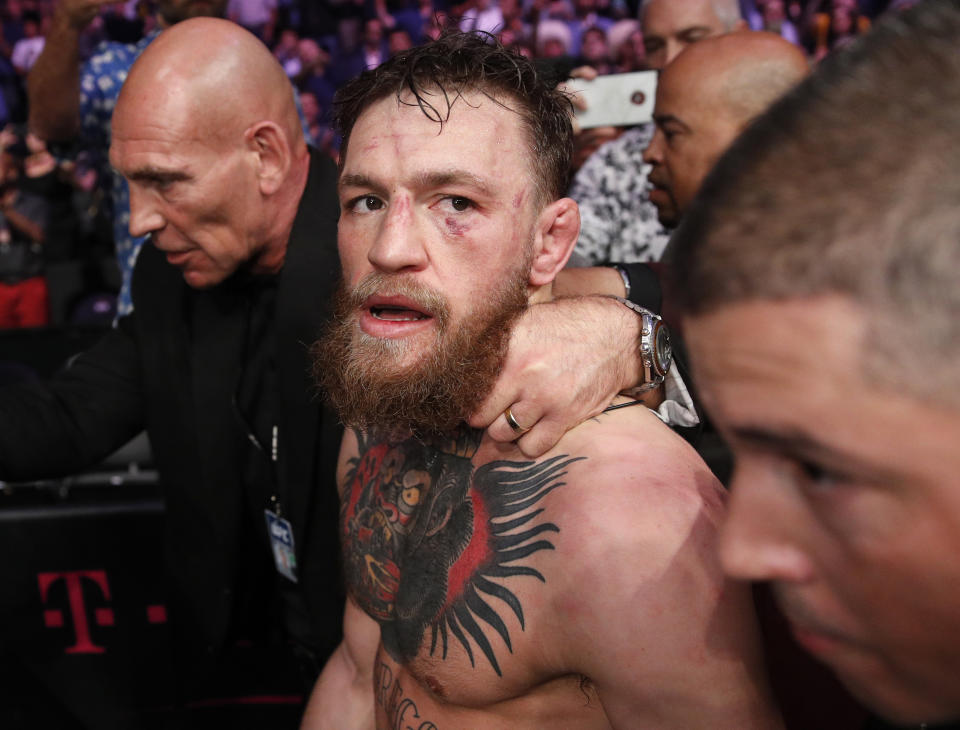 FILE - In this Oct. 6, 2018, file photo, Conor McGregor walks out of the arena after he was defeated by Khabib Nurmagomedov in a lightweight title mixed martial arts bout at UFC 229 in Las Vegas. Superstar UFC fighter McGregor has announced on social media that he is retiring from mixed martial arts. McGregor’s verified Twitter account had a post early Tuesday, March 26, 2019, that said the former featherweight and lightweight UFC champion was making a “quick announcement.”(AP Photo/John Locher, File)