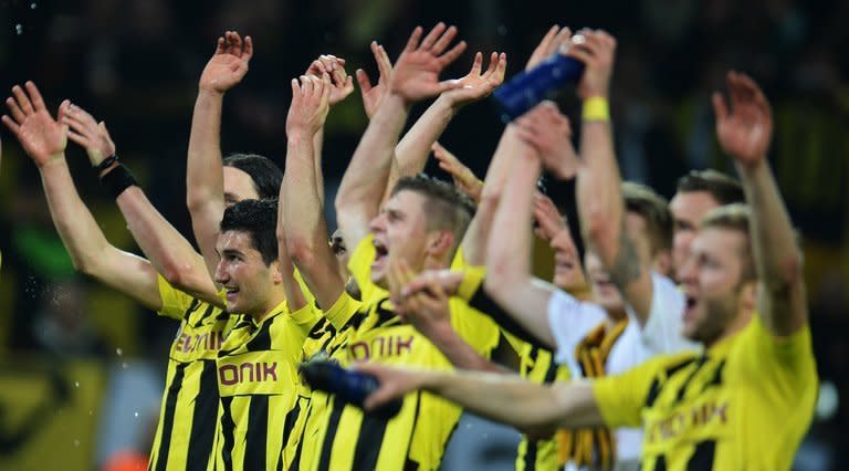 Dortmund players celebrate after they defeat Malaga in the Champions League quarter-final second-leg on April 9, 2013. Dortmund were 2-1 down in added time when Marco Reus and then Felipe Santana grabbed 91st and 93rd-minute goals respectively to put them through 3-2 on aggregate