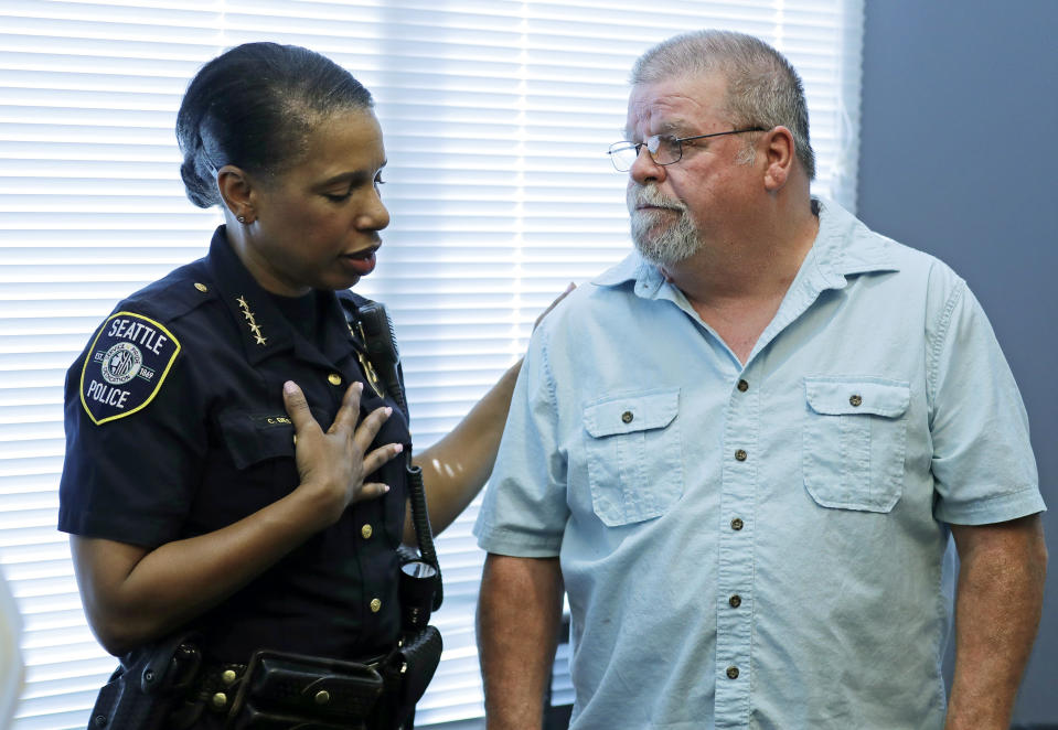 Seattle Police Chief Carmen Best, left, talks with Chris Galvin, Tuesday, May 7, 2019, in Seattle. Seattle police said Tuesday they have solved the 1967 cold case of the murder of Chris' sister, Susan Galvin, with the help of DNA and a family tree -- a method that has revolutionized cold-case investigations across the U.S. (AP Photo/Ted S. Warren)