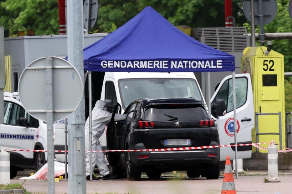 A forensic team at work at the site of the ambush (AFP via Getty)