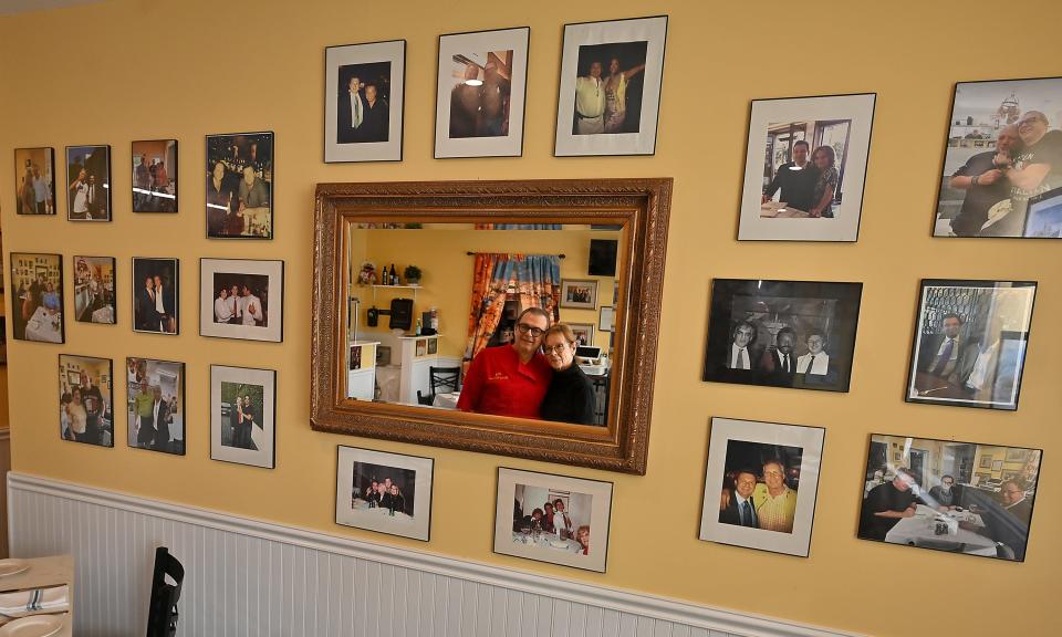 Mama Italia Ristorante owners Marco and Kathy Baldieri display a wall of photos of celebrities who have visited the chef’s restaurants.