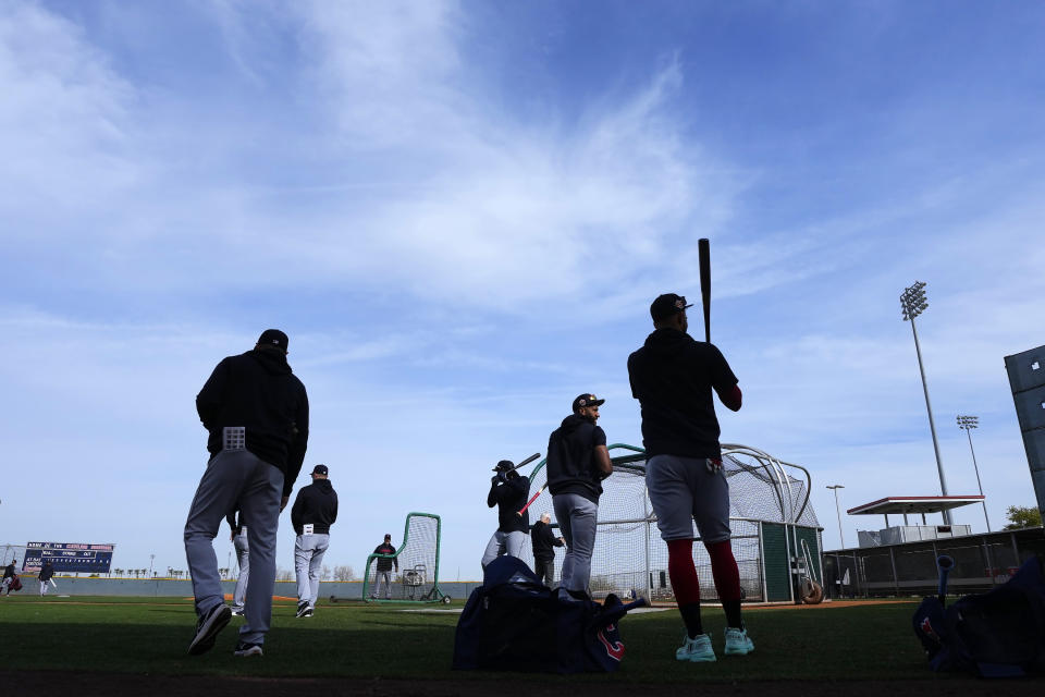 Cleveland Guardians position players and coaches prepare for batting practice during the first day of spring training baseball workouts for the Guardians in Goodyear, Ariz., Friday, Feb. 17, 2023. (AP Photo/Ross D. Franklin)