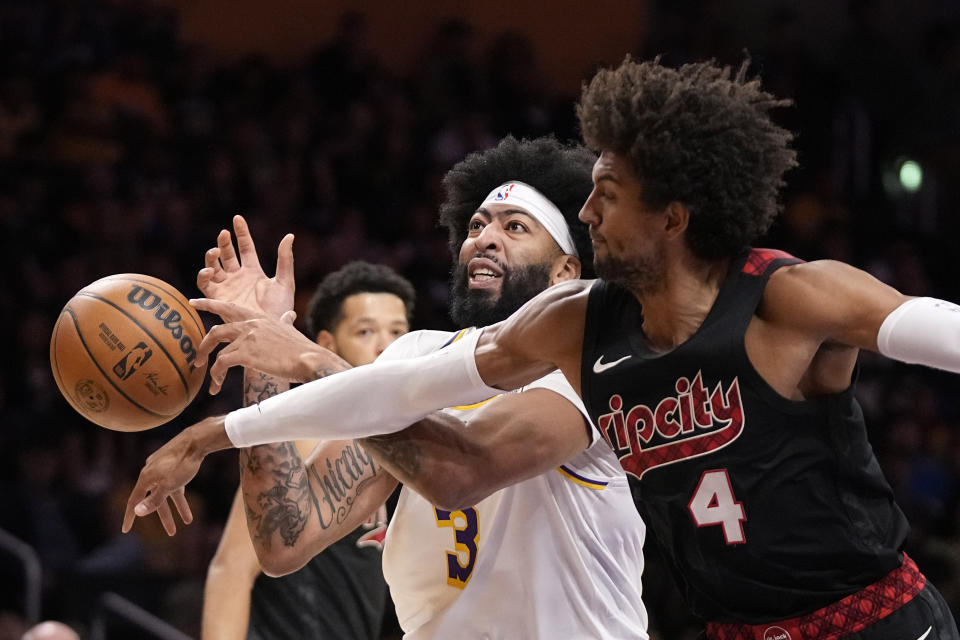 Portland Trail Blazers guard Matisse Thybulle, right, knocks the ball from the hands of Los Angeles Lakers forward Anthony Davis during the first half of an NBA basketball game Sunday, Nov. 12, 2023, in Los Angeles. (AP Photo/Mark J. Terrill)