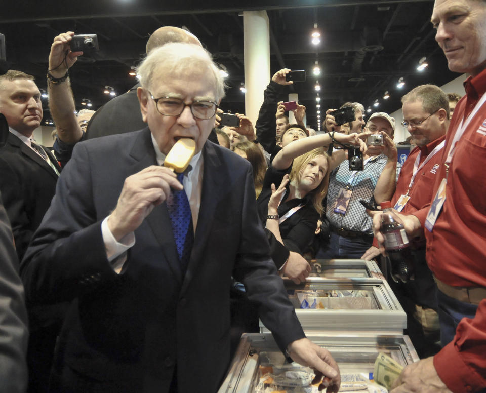 Warren Buffett, chairman and CEO of Berkshire Hathaway, eats an ice cream bar made by Berkshire subsidiary Dairy Queen prior to the annual shareholders meeting in Omaha, Neb., Saturday, May 5, 2012. Berkshire Hathaway is holding it's annual shareholders meeting this weekend. (AP Photo/Dave Weaver)