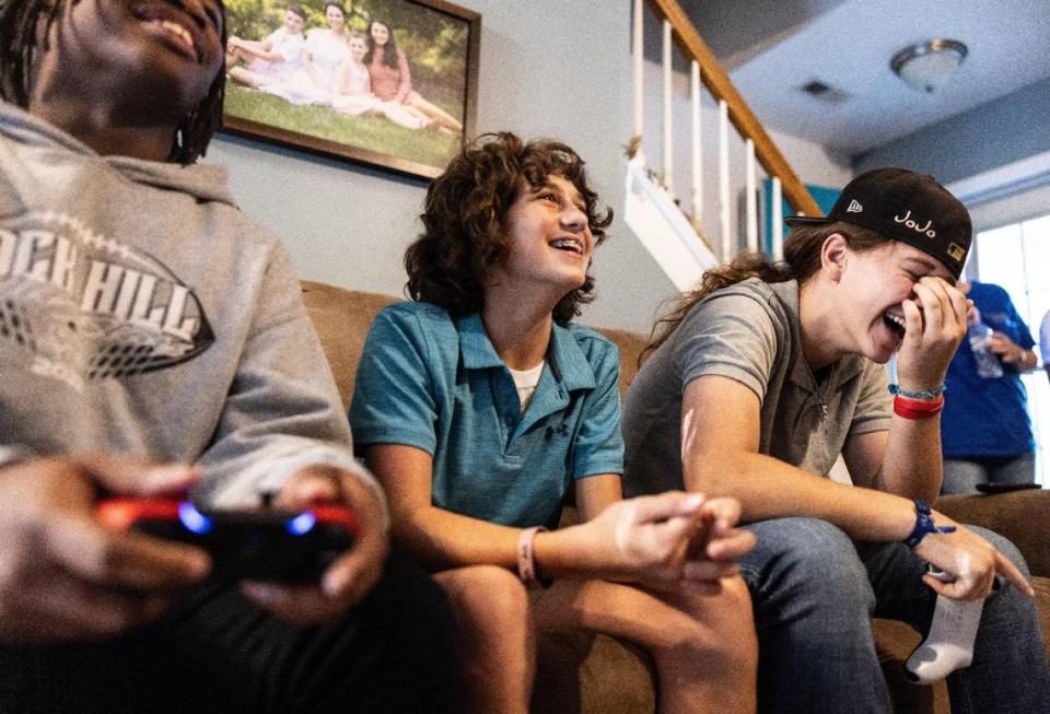 “There’s a bunch of girls who came out for our spring training,” says Jo, pictured at right while playing video games with Sullivan teammates Reece Nahrgang (center) and Dontavious Cousar. “They came for the first day, found out how hard our conditioning was, and then never came back. Their helmets are still hanging up in the locker room.” Khadejeh Nikouyeh/Knikouyeh@charlotteobserver.com