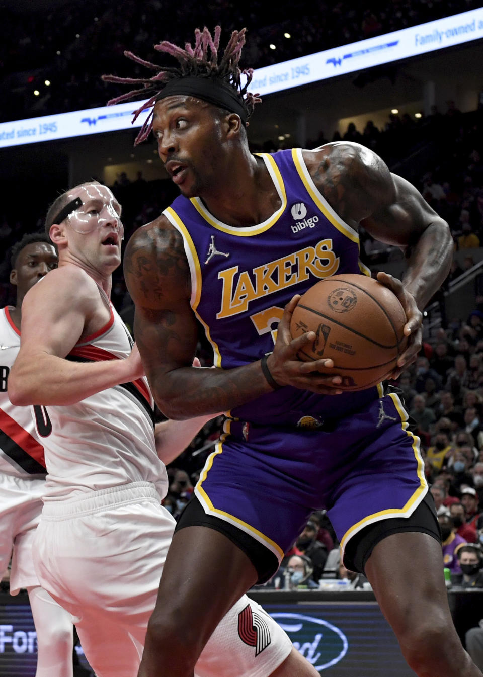 Los Angeles Lakers center Dwight Howard, right, grabs a rebound in front of Portland Trail Blazers center Cody Zeller during the first half of an NBA basketball game in Portland, Ore., Saturday, Nov. 6, 2021. (AP Photo/Steve Dykes)