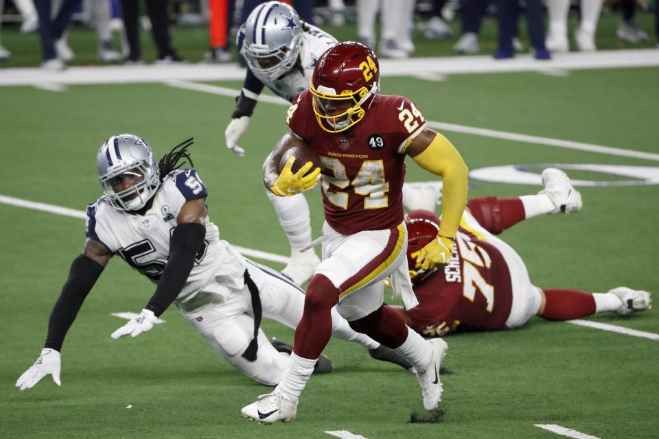 Washington Football Team running back Antonio Gibson (24) sprints to the end zone past Dallas Cowboys linebacker Jaylon Smith (54) for a touchdown in the second half of an NFL football game in Arlington, Texas, Thursday, Nov. 26, 2020. (AP Photo/Roger Steinman)