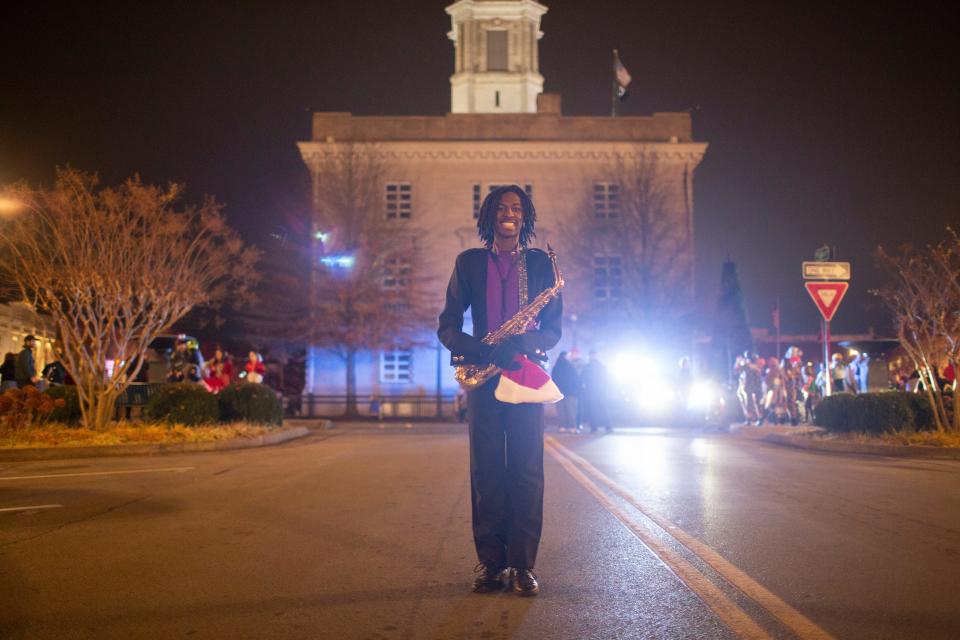 Columbia Central High School senior Lawayne Stovall stands on North Main Street after marching in the Columbia Main Street Christmas Parade in Columbia, Tenn., on Saturday, Dec. 4, 2021.