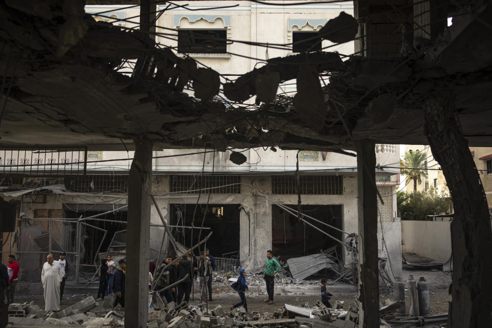 Palestinians look at the destruction after an Israeli strike in Rafah, southern Gaza Strip, Wednesday, Jan. 3, 2024. (AP Photo/Fatima Shbair)