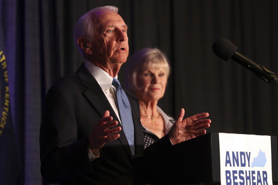 Former Kentucky Gov. Steve Beshear, left, accompanied by his wife Jane, speaks to supporters of his son after he won the Democrat primary election at the Kentucky Historical Society in Frankfort, Ky., Tuesday, May 16, 2023. (AP Photo/James Crisp)