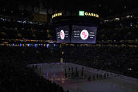 House lights are dimmed during a moment of silence for the victims of the Covenant School shooting, before an NHL hockey game between the Nashville Predators and the Boston Bruins, Tuesday, March 28, 2023, in Boston. (AP Photo/Charles Krupa)