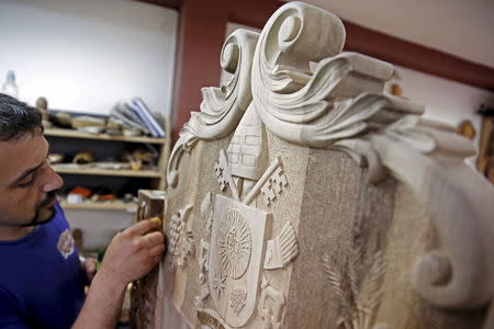 Bosnian wood carver-sculptor Edin Hajderovac works on a chair for Pope Francis, at his workshop in Zavidovici, Bosnia and Herzegovina, in this May 25, 2015 file photo. REUTERS/Dado Ruvic/Files