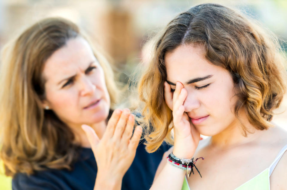 Woman comforting a distressed teen, illustrating parental care and support