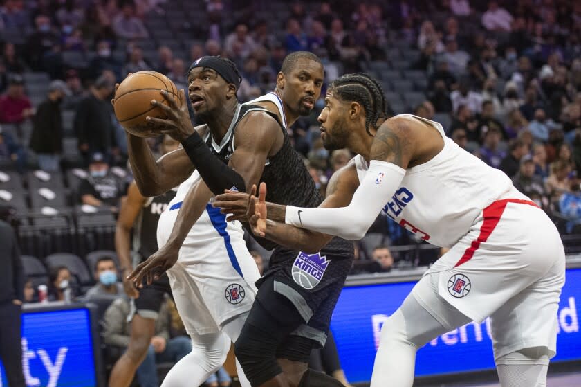 Sacramento Kings guard Terence Davis, left, drives to the basket past Los Angeles Clippers center.