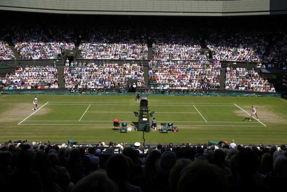 Germany's Tatjana Maria, right, returns to Tunisia's Ons Jabeur in a women's singles semifinal match on day eleven of the Wimbledon tennis championships in London, Thursday, July 7, 2022. (AP Photo/Alastair Grant)