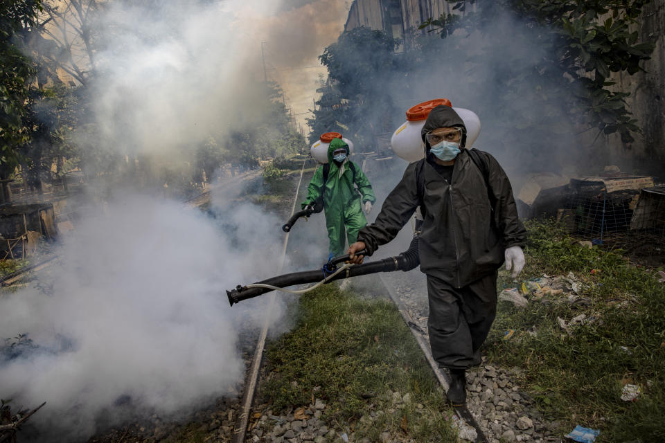 Workers wearing a hazmat suits disinfect a slum community along a railway as preventive measure against COVID-19 on March 26, 2021 in Manila, Philippines. Curfews and stricter lockdowns are being implemented in several areas across the Philippines as the country experiences its worst surge in cases since the lockdown began more than a year ago. The country has reported more than 693,000 cases of COVID-19 so far, with at least 13,095 deaths. (Photo: Ezra Acayan/Getty Images)