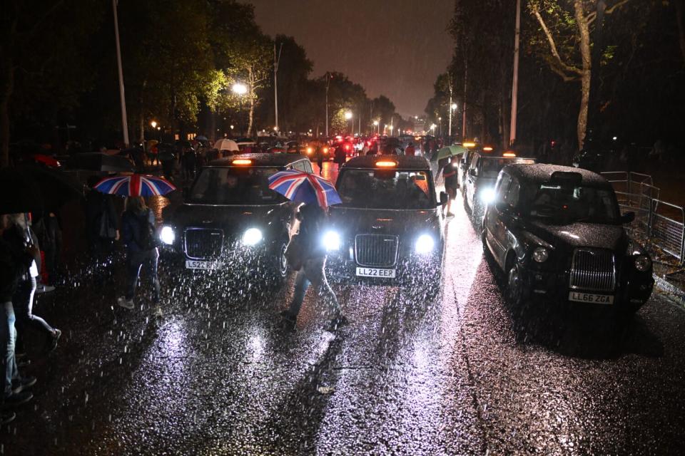 London black cabs line the Mall leading to Buckingham Palace during a silent tribute to Queen Elizabeth II.