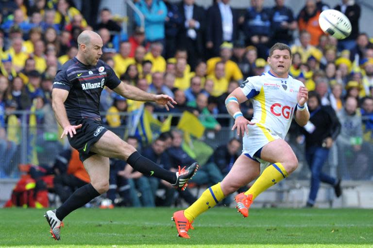 Saracens' British fly-half Charlie Hodgson (L) kicks the ball during the European Rugby Champions Cup semi-final match between Clermont and Saracens in Saint-Etienne, central France, on April 18, 2015