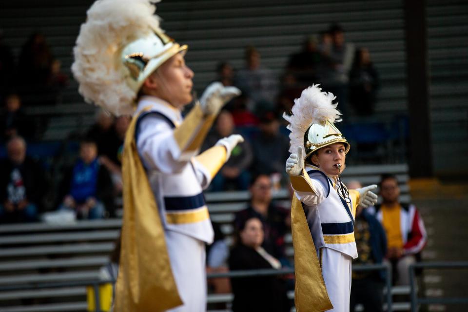 Drum majors of the Otswego Marching Band lead their ensamble through the grandstands Monday, Sept. 12, 2022, in Allegan. 