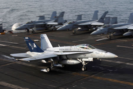 An F/A-18C Hornet of Strike Fighter Squadron (VFA) 37, lands on the flight deck of the U.S. aircraft carrier, USS George H. W. Bush in Gulf of Oman in this photo taken on March 20, 2017. REUTERS/Hamad I Mohammed