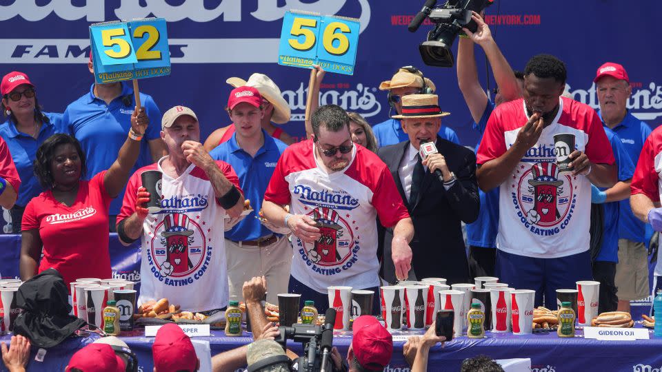 Patrick Bertoletti won the men's contest after chomping on 58 hot dogs and buns. - Jeenah Moon/Reuters