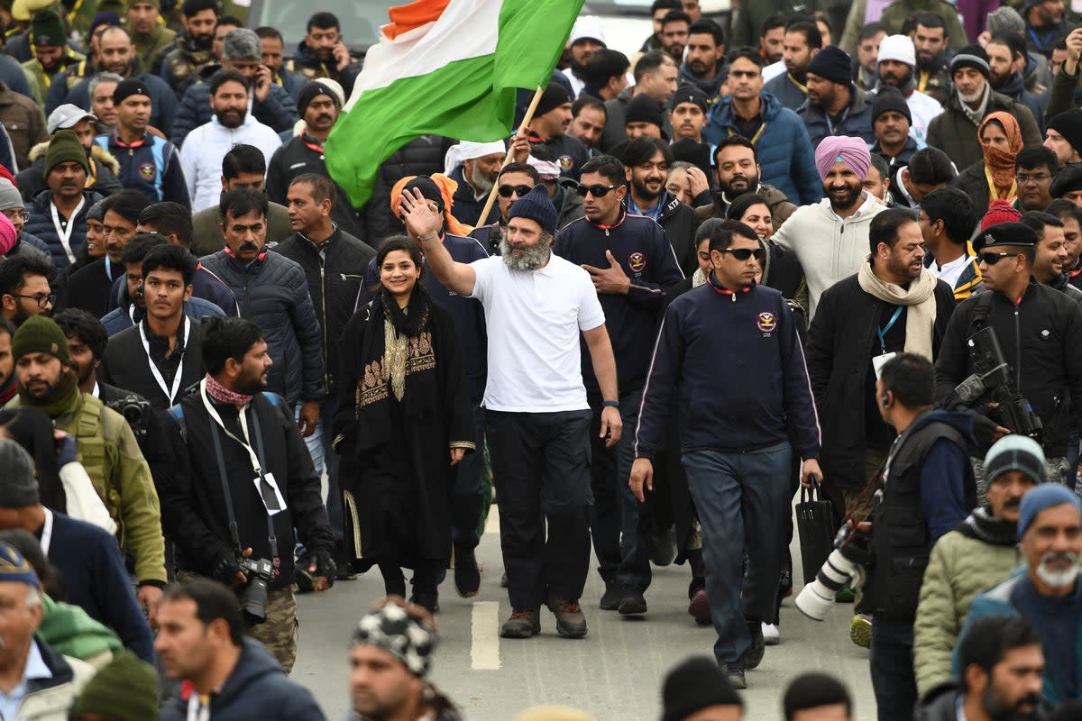 Indian Congress leader Rahul Gandhi (centre, in white) with Iltija Mufti (left) daughter of former chief minister of Jammu and Kashmir Mehbooba Mufti (not in photo) walk during the ‘Bharat Jodo Yatra’ in Anantnag, south Kashmir (AFP/Getty)