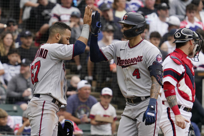 Minnesota Twins' Carlos Correa, right, celebrates with Gilberto Celestino after hitting a two-run home run during the fifth inning of a baseball game against the Chicago White Sox in Chicago, Sunday, Sept. 4, 2022. (AP Photo/Nam Y. Huh)