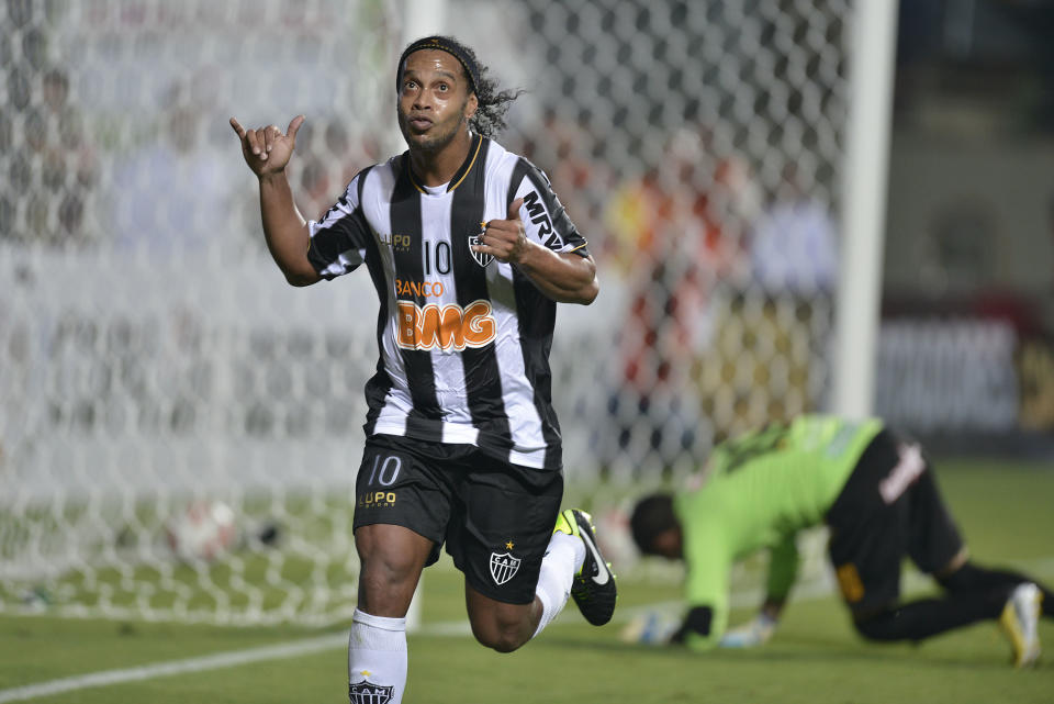 FILE - In this March 7, 2013 file photo, Brazil's Atletico Mineiro's Ronaldinho celebrates after scoring against Bolivia's The Strongest during a Copa Libertadores soccer match in Belo Horizonte, Brazil. Former Brazil star Ronaldinho remains one of the main attractions in the league, and for the third year in a row the 34-year-old playmaker will try to lead Atletico Mineiro to its first league title since 1971. Teammate Jo is one of the few league players who will be playing in the World Cup, along with Fred, the Fluminense striker who is set to start for Brazil. (AP Photo/Pedro Vilela, File)