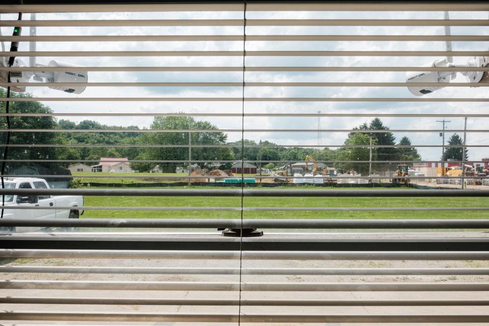 An ongoing construction project can be seen from the office of Gardner Street Garage, where owner John Fockler says the roadway to his property is frequently blocked and at time flooded.