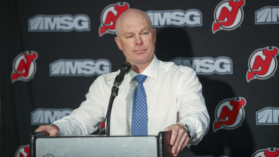 FILE - In this Monday, Oct. 14, 2019 file photo, New Jersey Devils head coach John Hynes talks to reporters after an NHL hockey game against the Florida Panthers in Newark, N.J. The New Jersey Devils have fired coach John Hynes. General manager Ray Shero announced the move Tuesday afternoon, Dec. 3, 2019 roughly 20 minutes before Hynes was to speak to the media before the Devils game against the Las Vegas Golden Knights at the Prudential Center. (AP Photo/Mary Altaffer, File)