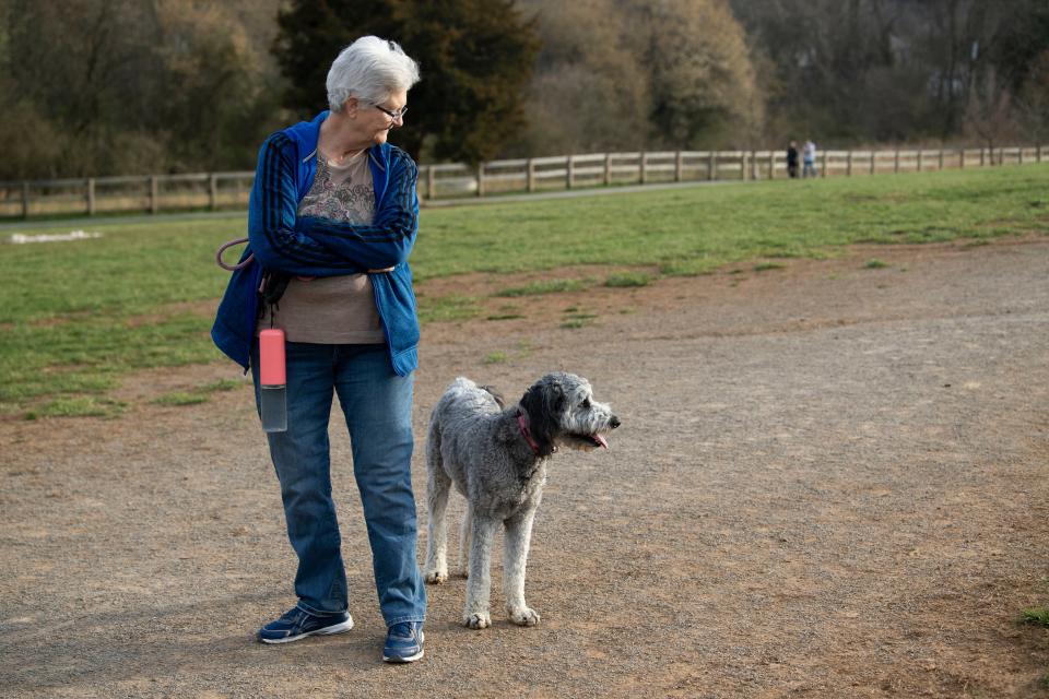 Bonnie Oberhaus with Maddie, Australian Shepherd and poodle mix at Plumb Creek Park on Tuesday, March 15, 2022.