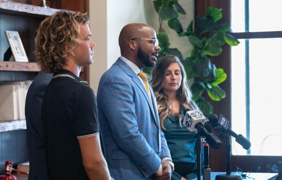 Clients Matthew Gilley, left, and Jordan Gray listen as attorney Aaron Watson talks during a press conference at the Watson Firm in Pensacola on June 14, 2023.  Matthew Gilley, Jordan Gray, and Brandon Gray all tested positive for methamphetamines after eating at Nikko Japanese Steak House and Sushi Bar in Pace on Friday, June 9, 2023.