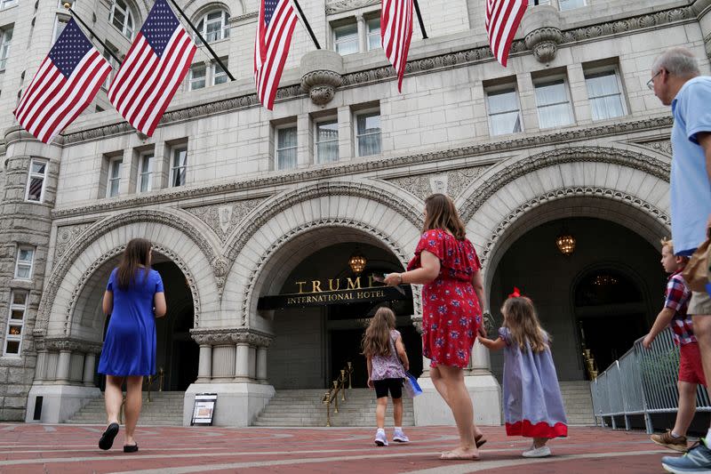 FILE PHOTO: A group of people approach the front facade of the Trump International Hotel to pose for photos in Washington